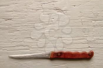 A very old kitchen knife that was grinded off from constant use on a rough wooden board