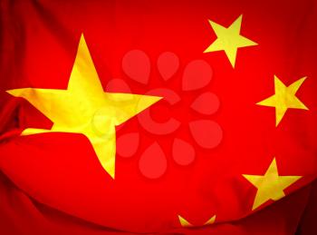 Red with yellow stars waving flag of the People's Republic of China close-up