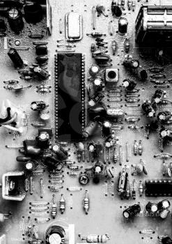 Old printed circuit board with resistors and capacitors from an analog TV close-up