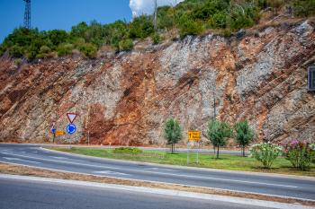 Highway in Montenegro along a mountainous section with a road sign to Tivat and Budva