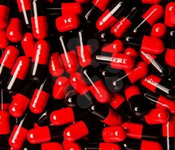 background of many red-black pills in capsules