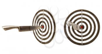 large sharp steel kitchen knife sticking out in the center of a wooden target isolated on white background