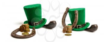 classic green leprechaun hat and a few different coins on a white background