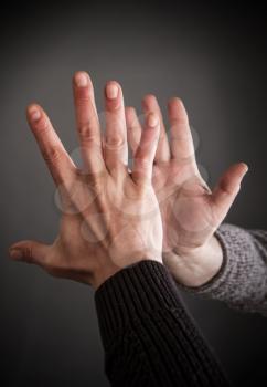 Close-up two male hands greet each other clapping hands 