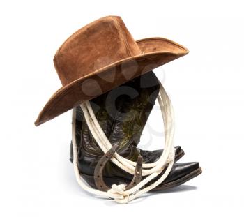 Shabby old ornate classic cowboy boots hat and lasso on white background