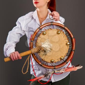 The girl plays the tambourine. According to legends, every system administrator, when something breaks down in the server room, must perform a magic ritual using a shaman tambourine.
