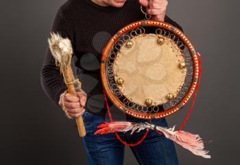 The man plays the tambourine. According to legends, every system administrator, when something breaks down in the server room, must perform a magic ritual using a shaman tambourine.