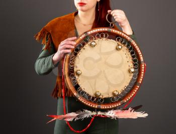The girl plays the tambourine. According to legends, every system administrator, when something breaks down in the server room, must perform a magic ritual using a shaman tambourine.