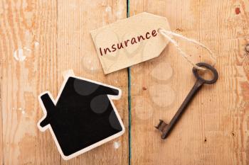 home insurance concept - little house and old key