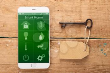 Smartphone with smart home app on the wooden desk