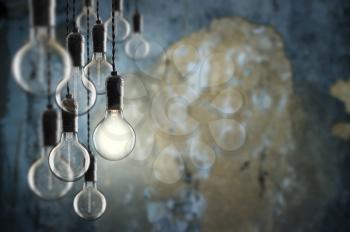 Idea and leadership concept Vintage  bulbs on wall background,  copy space for text