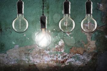 Idea and leadership concept Vintage  bulbs on wall background,  copy space for text