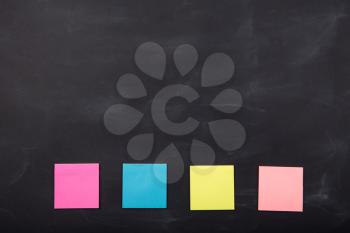 Colorful sticky notes on the blank blackboard