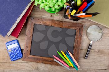 school supplies and blackboard with copy space on table