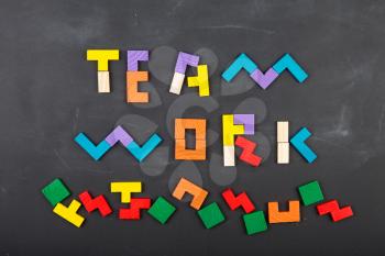 Teamwork creative concept - jigsaw on the blackboard