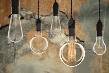 Idea and leadership concept Vintage incandescent Edison type bulbs on color wall