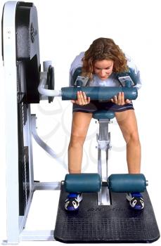 Royalty Free Photo of a Woman on Weight Lifting Machine