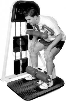Royalty Free Photo of a Man on a Weight Lifting Machine
