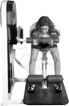 Royalty Free Photo of a Woman on a Weight Lifting Machine