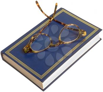 Royalty Free Photo of a Book With Reading Glasses on Top