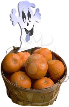Royalty Free Photo of a Basket of Pumpkins with a Ghost Decoration
