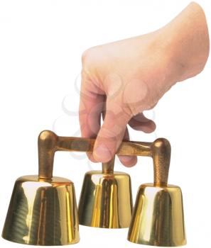 Royalty Free Photo of a Hand holding a Set of Brass Bells on a White Background