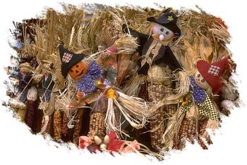 Royalty Free Photo of a Trio of Scarecrows in the Field