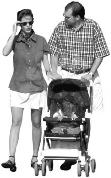 Royalty Free Photo of a Couple Walking Their Baby