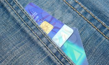 Credit cards placed to the jeans pocket.