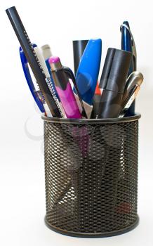 Colored pen and pencil in office pot, isolated on white background.
