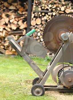 Circular saw with woodshed in background.