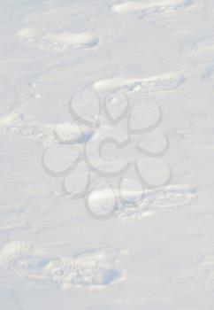 Image of several footprints in snow.