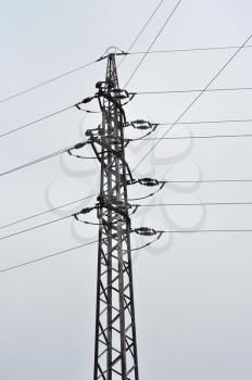 The pole with high voltage wire.