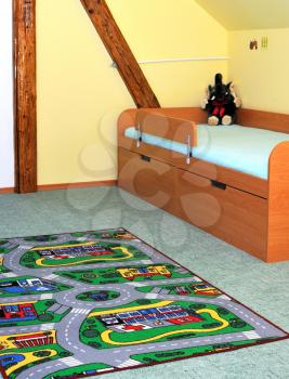 View into the children's room with color carpet.
