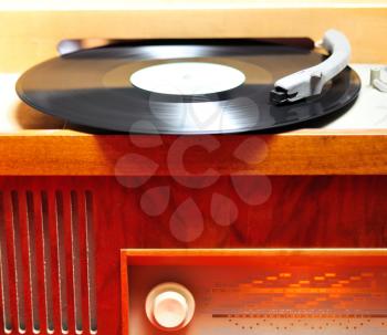 Closeup view at retro vinyl wood gramophone.