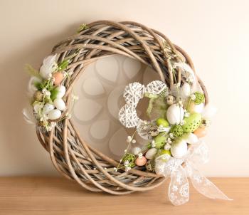 Easter decoration on the table, wreath with eggs.