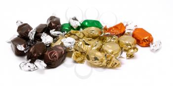 Packed candies in different color placed on a white background.