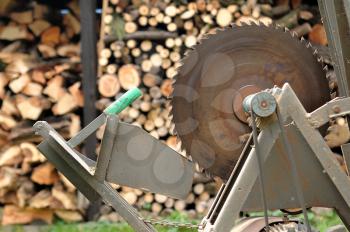 Circular saw with woodshed in background.