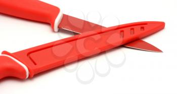 Two red ceramic knives placed on a white background.