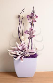 Interior decoration, decorative purple flower on a wooden desk.
