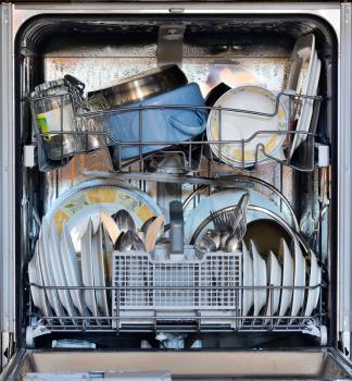 Open the front door of the dishwasher full of clean dishes