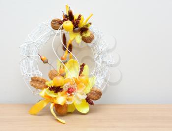 Closeup shot with autumn decoration on the table. Wreath with nuts and acorns.