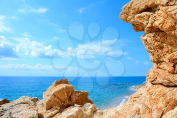 Beautiful beach with clear Mediterranean Sea and rock on the coast.