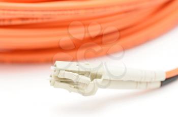 Closeup of the optical fiber cable and LC connector on a white background. 