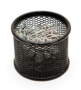 Paper clips in the black metal office pot on a white background.