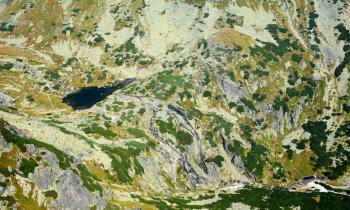 Abstract top down view of mountain valley with glacial lake. It looks like as nature background.