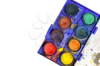 Top down view of old used watercolor box isolated on white. Copy space on left side.