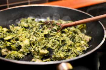 Cooking a spinach pasta in pan.