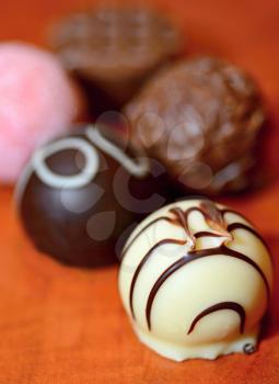 A Close up of Various Belgian Chocolate Pralines on Wooden background.