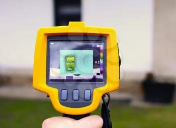 Recording Heat Loss of a House facade with Infrared Thermal Camera in Hand. 